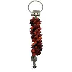 PERUVIANE - Adorno colgador de pared con semillas de huayruro y dije de Tumi