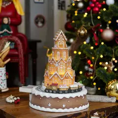 GENERICO - Villa navideña con tren rodando en casa de jengibre