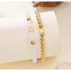 MORITA BAG STORE - CONJUNTO DE DOS PULSERAS TIPO PERLA BLANCO Y DORADO CON UN CORAZON